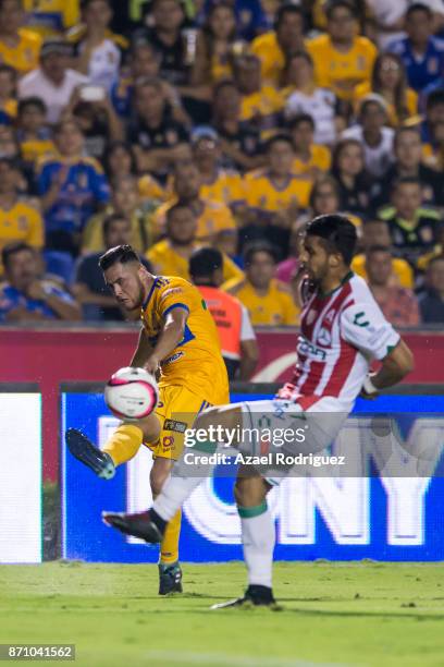 Israel Jimenez of Tigres kicks the ball over Daniel Alvarez of Necaxa during the 16th round match between Tigres UANL and Necaxa as part of the...