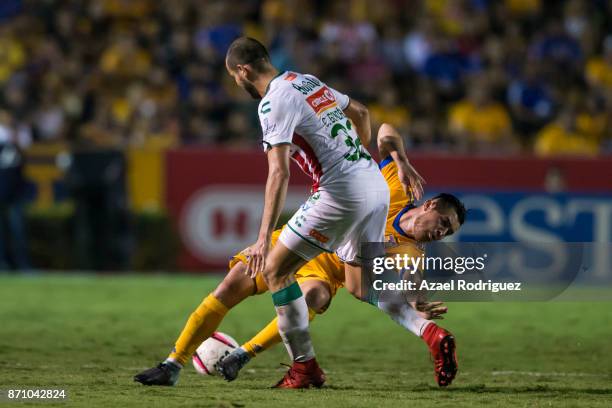 Israel Jimenez of Tigres fights for the ball with Carlos Gonzalez of Necaxa during the 16th round match between Tigres UANL and Necaxa as part of the...