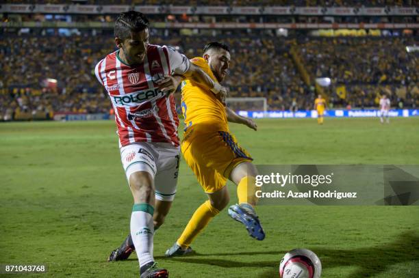 Israel Jimenez of Tigres fights for the ball with Miguel Angel Ponce of Necaxa during the 16th round match between Tigres UANL and Necaxa as part of...