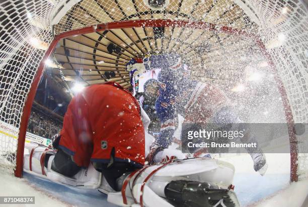 Rick Nash of the New York Rangers crashes into Sergei Bobrovsky of the Columbus Blue Jackets during the first period at Madison Square Garden on...