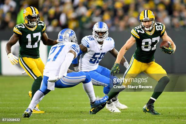 Jordy Nelson of the Green Bay Packers runs with the ball while being chased by Glover Quin of the Detroit Lions in the first quarter at Lambeau Field...