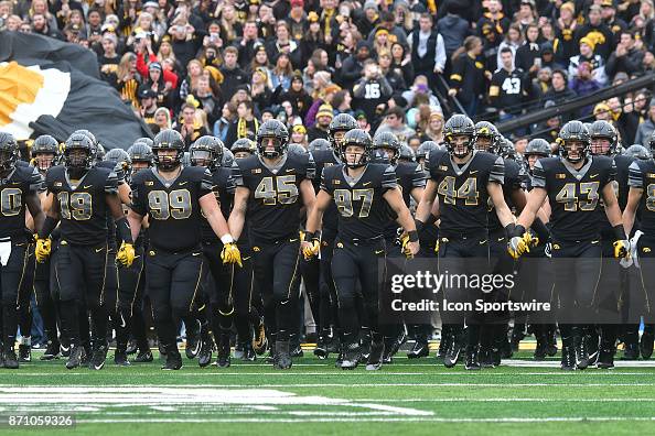 The Iowa Hawkeyes enter the field wearing a special uniform before a