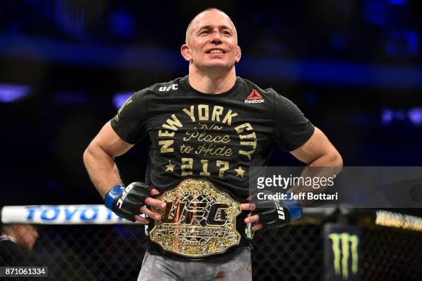 Georges St-Pierre of Canada celebrates after defeating Michael Bisping of England in their UFC middleweight championship bout during the UFC 217...
