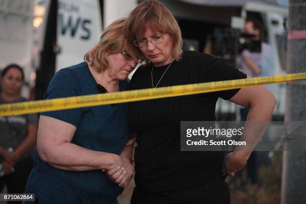 Joan Stanley and her daughter Kellie Hawkins embrace at a barricade near the First Baptist Church of Sutherland Springs on November 6, 2017 in...