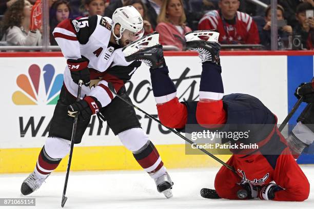 Nicklas Backstrom of the Washington Capitals crashes to the ice after colliding with Brad Richardson of the Arizona Coyotes during the third period...