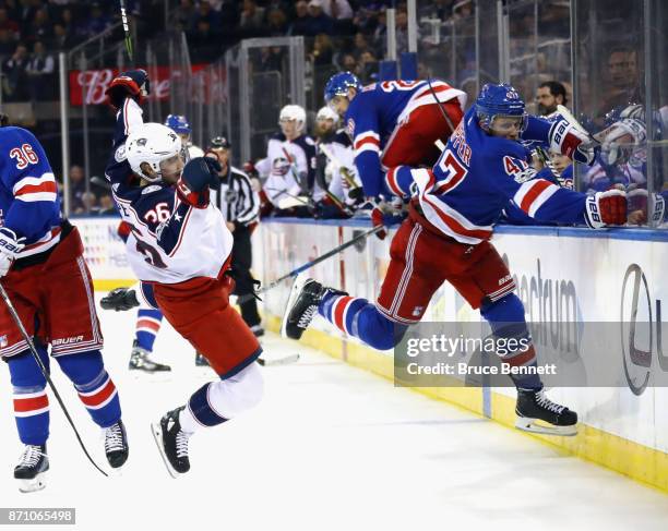 Steven Kampfer of the New York Rangers hits Zac Dalpe of the Columbus Blue Jackets during the third period at Madison Square Garden on November 6,...