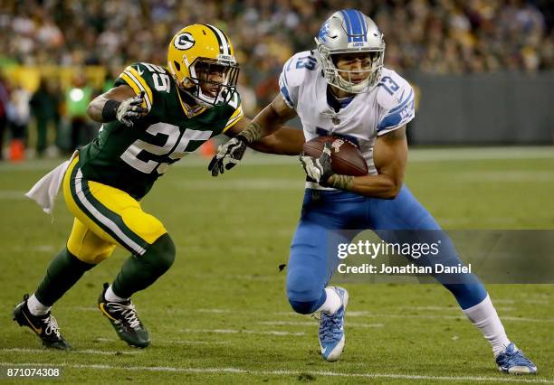 Jones of the Detroit Lions runs with the ball pursued by Marwin Evans of the Green Bay Packers in the third quarter at Lambeau Field on November 6,...