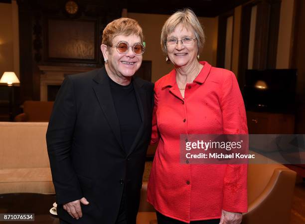 Founder Elton John and president of Harvard University Drew Gilpin Faust meet at Winthrop House on November 6, 2017 in Cambridge, Massachusetts.