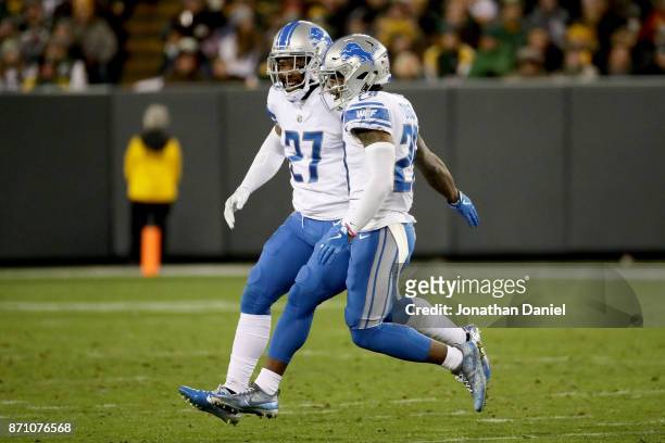 Glover Quin and Quandre Diggs of the Detroit Lions celebrate in the third quarter against the Green Bay Packers at Lambeau Field on November 6, 2017...
