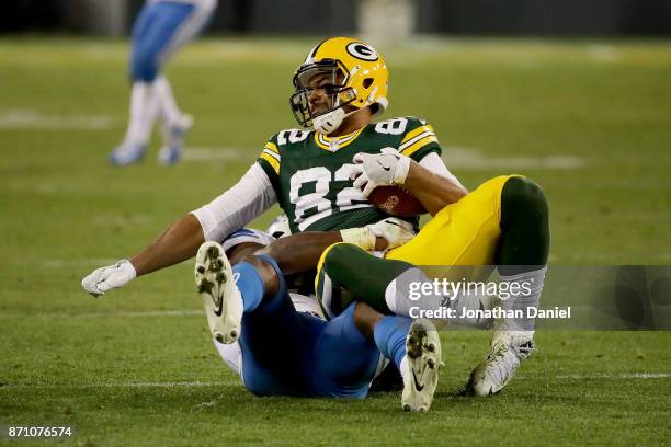 Jarrad Davis of the Detroit Lions tackles Richard Rodgers of the Green Bay Packers in the fourth quarter at Lambeau Field on November 6, 2017 in...