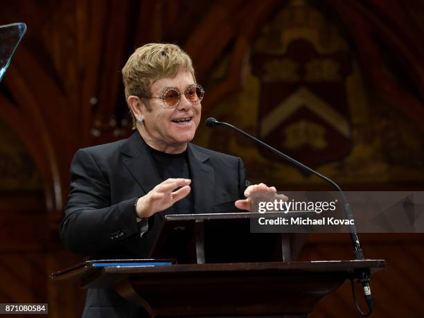 Founder Elton John presents onstage as he accepts the Peter J. Gomes Humanitarian of the Year Award from the Harvard Foundation for his work towards...