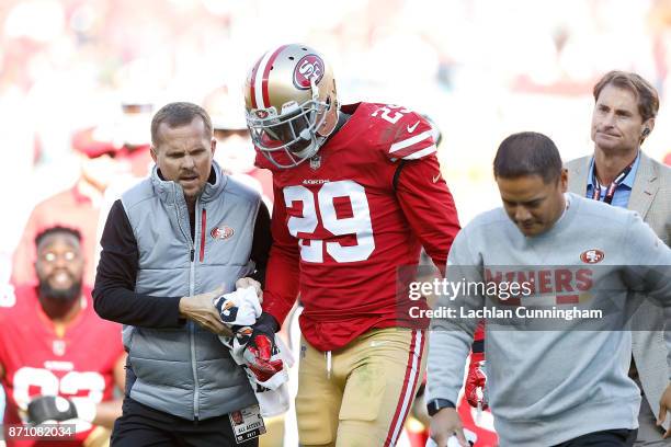 Jaquiski Tartt of the San Francisco 49ers is assisted from the field during the game against the Arizona Cardinals at Levi's Stadium on November 5,...