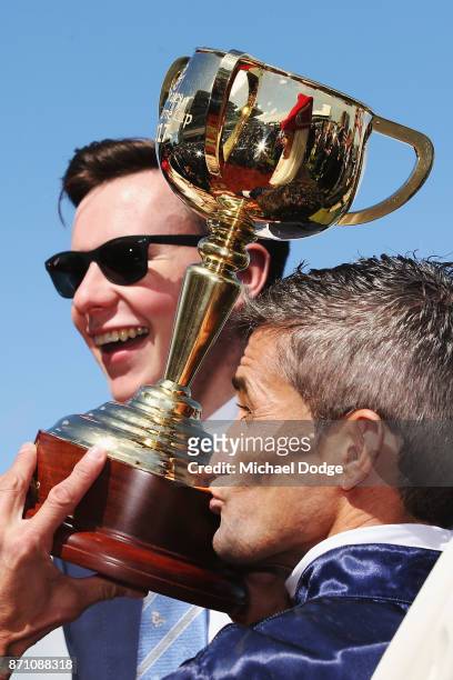 Jockey Corey Brown kisses the Melbourne Cup next to winning trainer Jospeh O'Brien after winning on Rekindling to win race 7 the Emirates Melbourne...