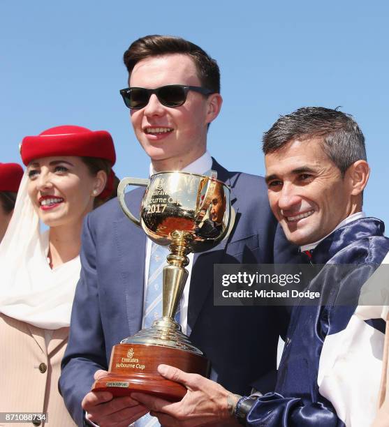 Jockey Corey Brown poses with the Melbourne Cup next to winning trainer Joseph O'Brien after winning on Rekindling to win race 7 the Emirates...