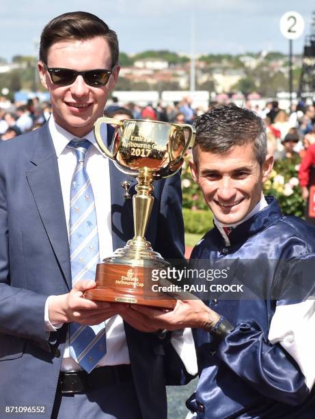 Corey Brown jockey of Rekindling and trainer Joseph O'Brien hold the trophy after they won the 157th Melbourne Cup at Flemington Racecourse in...
