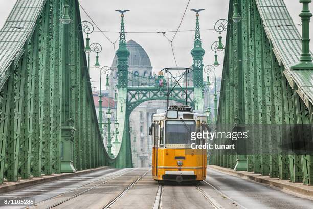 vintage cable car on liberty bridge - budapest stock pictures, royalty-free photos & images