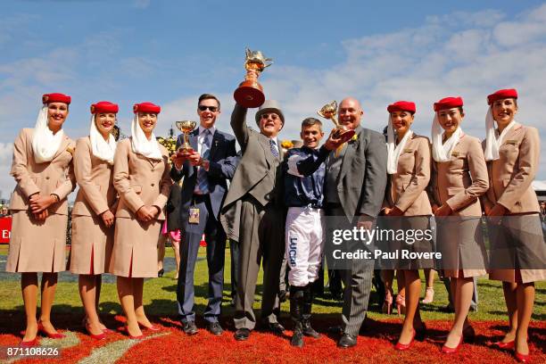 Trainer Joseph O'Brien, owner Lloyd Williams and jockey Corey Brown celebrate after winning the Melbourne Cup with their horse Rekindling on...