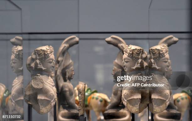 Statues are displayed in a gallery at the Louvre Abu Dhabi Museum during a media tour on November 6, 2017 prior to the official opening of the museum...