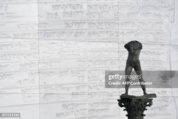 Staute of "Walking Man, On a Column" of Auguste Rodin, made in 2006 by Fonderie Coubertin is displayed in a gallery at the Louvre Abu Dhabi Museum...