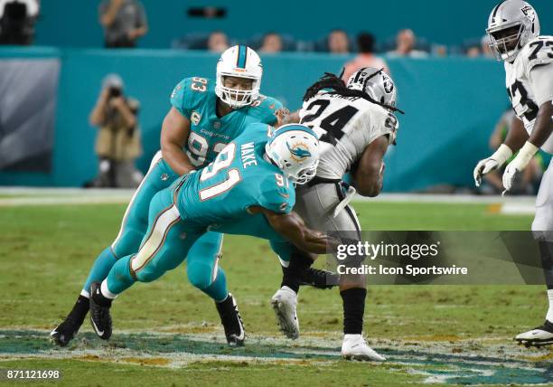 Miami Dolphins defensive end Cameron Wake tackles Oakland Raiders running back Marshawn Lynch during an NFL football game between the Oakland Raiders...