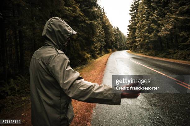 man walking alone in the road - parka stock pictures, royalty-free photos & images