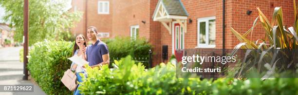 young househunting couple - model home exterior stock pictures, royalty-free photos & images