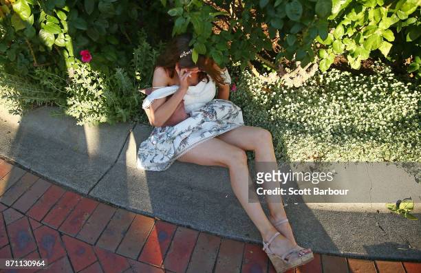 Racegoer stumbles as she makes her way home at the conclusion of the 2017 Melbourne Cup Day at Flemington Racecourse on November 7, 2017 in...