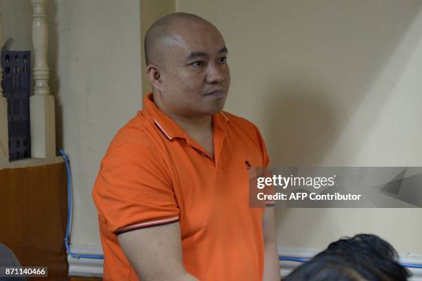 Philippine doctor Russell Salic listens during a court hearing in Manila on November 7, 2017. A Philippine doctor accused of wiring money for a...