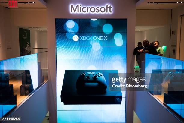 An advertisement for Xbox One X game console is displayed on a large screen during the Microsoft Corp. Global launch event in New York, U.S., on...