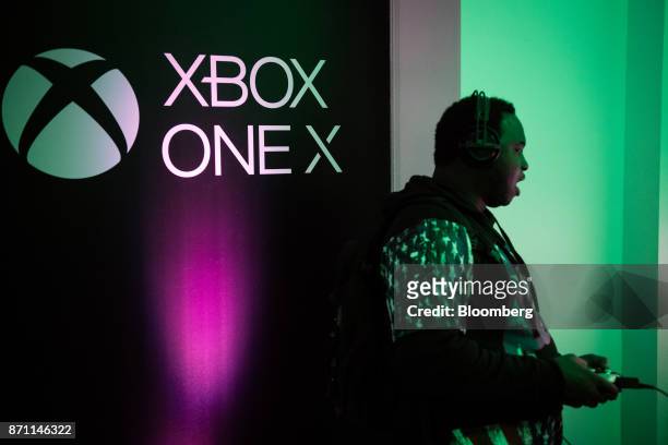 Customer plays on an Xbox Developer Kit version of the Xbox One X game console during the Microsoft Corp. Global launch event in New York, U.S., on...