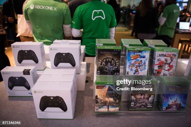 Xbox One X game console accessories and video games sit on display during the Microsoft Corp. Global launch event in New York, U.S., on Monday, Nov....