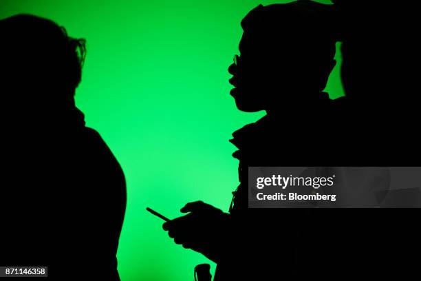 Customer is silhouetted while waiting in line to purchase an Xbox One X game console during the Microsoft Corp. Global launch event in New York,...