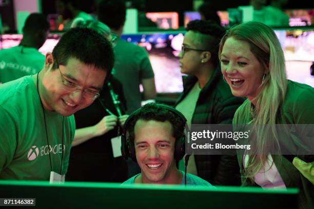 Customer plays on an Xbox Developer Kit version of the Xbox One X game console during the Microsoft Corp. Global launch event in New York, U.S., on...