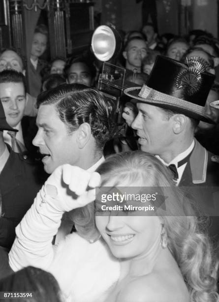 Anita Ekberg and Anthony Steele caught in the surging crowds outside the Empire Theatre Leicester Square. The couple were attending the premiere of...