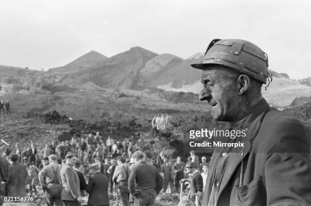 Rescue workers take a break from searching following the catastrophic collapse of a colliery spoil tip in the Welsh village of Aberfan, near Merthyr...