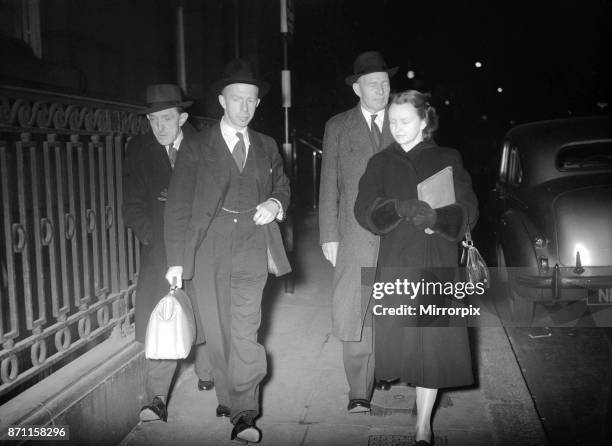 Dr. Keith Simpson, the Home Office pathologist, arriving at the Ritz hotel shortly before seven o'clock last night with his secretary Jean Scott Dunn...