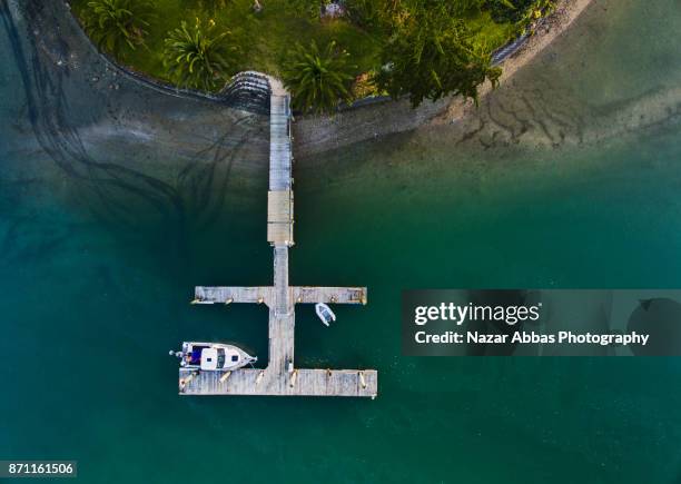 aerial view of jetty with boat parked. - whangaparoa peninsula bildbanksfoton och bilder
