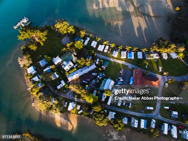 top looking down at motorhome park, auckland, new zealand. - whangaparoa peninsula stock pictures, royalty-free photos & images