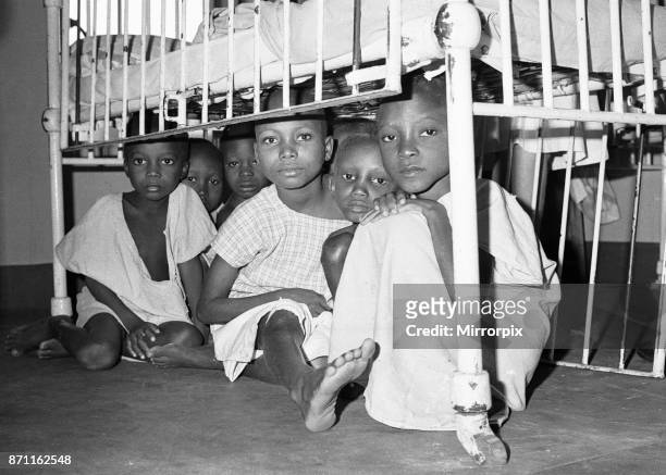 Children suffering from malnutrition hide under a cot during an air raid at Queen Elizabeth Hospital, Umuahia just one of the estimated one to two...