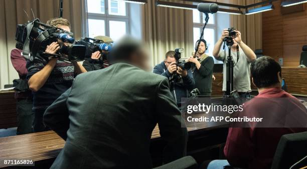 Huseen K. , who is accused of raping and killing a young woman in October 2016, and his lawyer Sebastian Glathe sit in the courtroom at the regional...