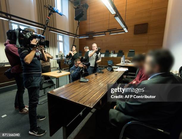 Photographers and cameramen take pictures of Huseen K. , who is accused of raping and killing a young woman in October 2016, and his lawyer Sebastian...