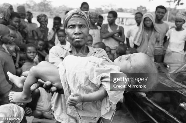 Mother seen here holding the dead body of her baby girl, just one of the estimated one to two million victims of the Biafran War, 23rd June 1968 .