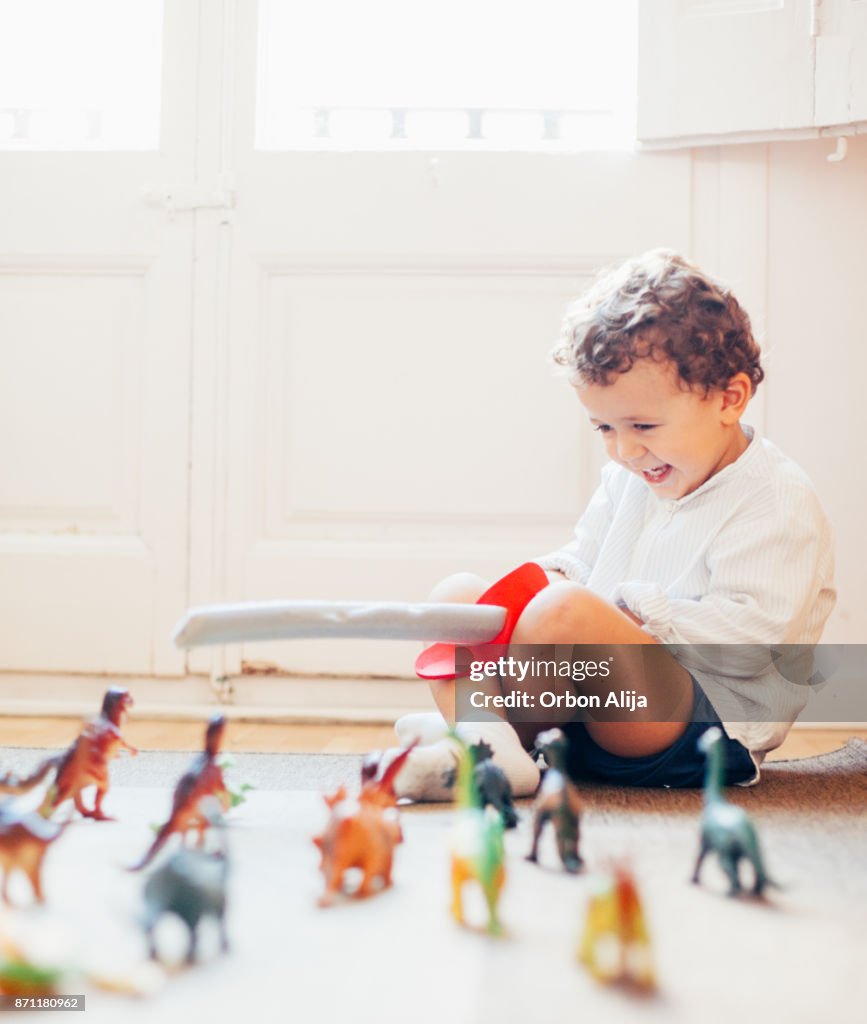 恐竜、おもちゃで遊ぶ少年