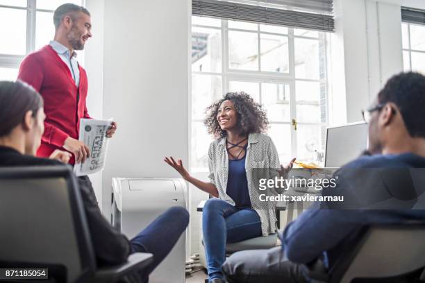 afrikaanse vrouw praten met haar collega's aan zakelijke bijeenkomst in het kantoor - arrogant stockfoto's en -beelden