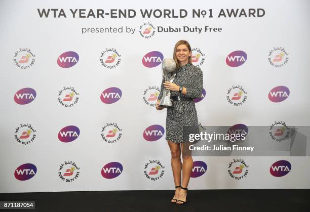 Simona Halep of Romania poses with the WTA Year-End World No.1 Award presented by Dubai Duty Free during day 8 of the BNP Paribas WTA Finals...