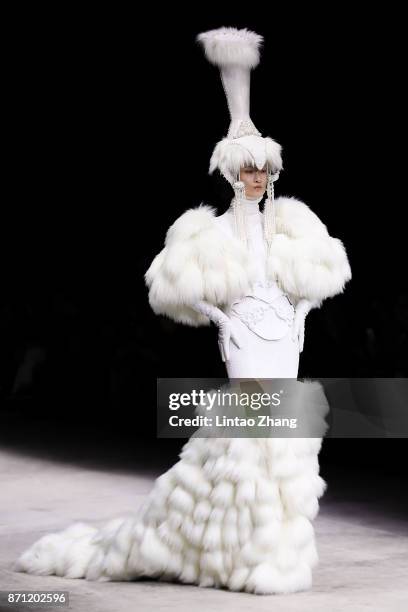 Model showcases designs on the runway at the Haute Couture Collection show by designer Hu Sheguang during the Mercedes-Benz China Fashion Week...