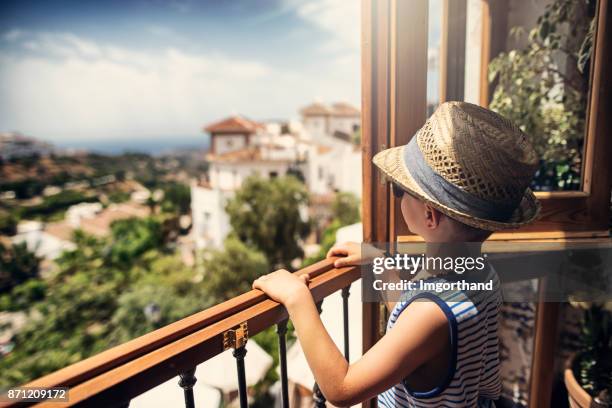 little boy looking at the view of beautiful andalusian white village - frigiliana stock pictures, royalty-free photos & images