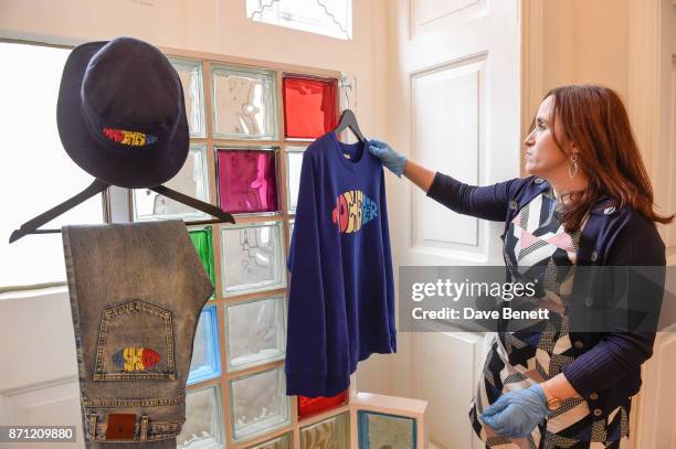 Staff member at Somerset House puts the finishing touches to a collection by fashion designer Paul Smith during a press preview of 'North: Fashioning...