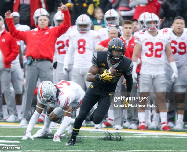 Running back Akrum Wadley of the Iowa Hawkeyes breaks a tackle during the second quarter by cornerback Damon Arnette of the Ohio State Buckeyes on...