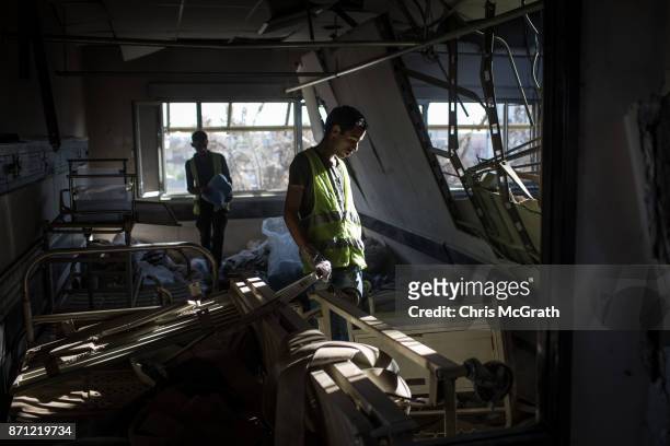 Volunteer looks for useful medical items inside the destroyed Salam Hospital on November 5, 2017 in Mosul, Iraq. Salam Hospital, Mosul's main hosptal...